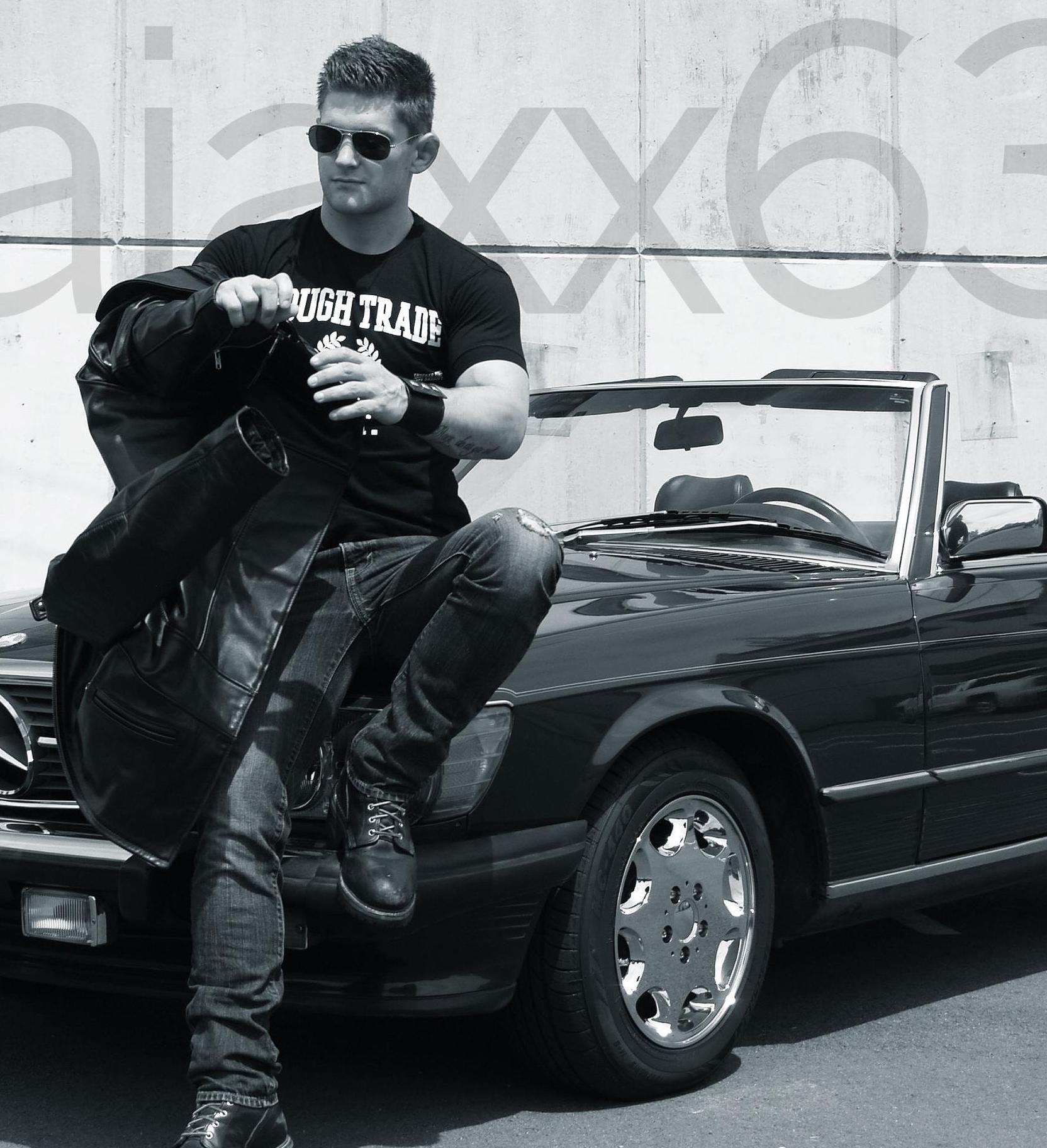 hot guy leaning on a vintage black mercedes convertible wearing rough trade ajaxx63 tee